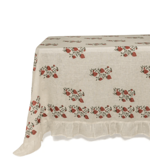 White Tablecloth with strawberry pattern and ruffled border sitting on table